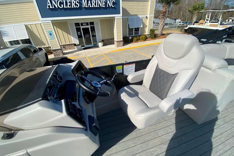 Slide: The Image of 2024 Starcraft SLS 3 boat interior with captain's chair and steering wheel at Anglers Marine NC. - 21