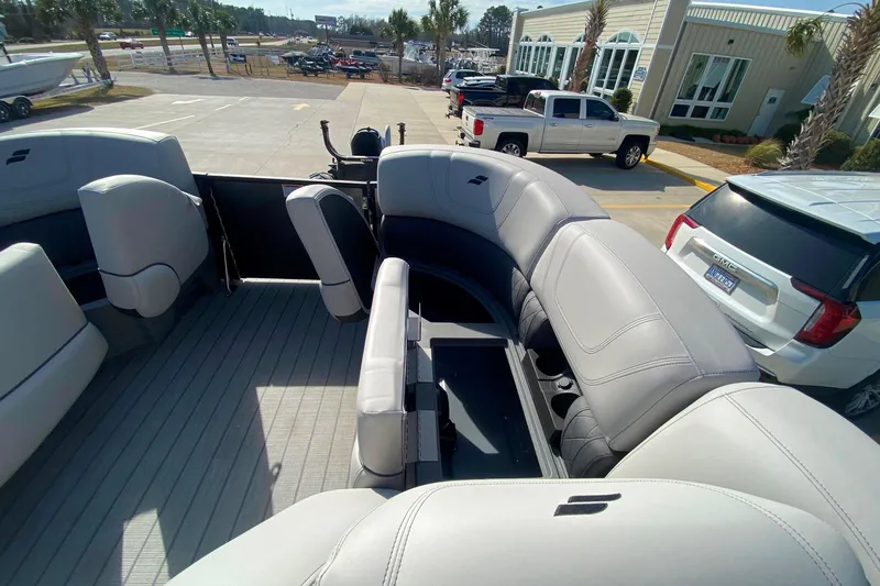 Slide: The Image of 2024 Starcraft SLS 3 boat interior with plush seating and modern design in a parking lot. - 14