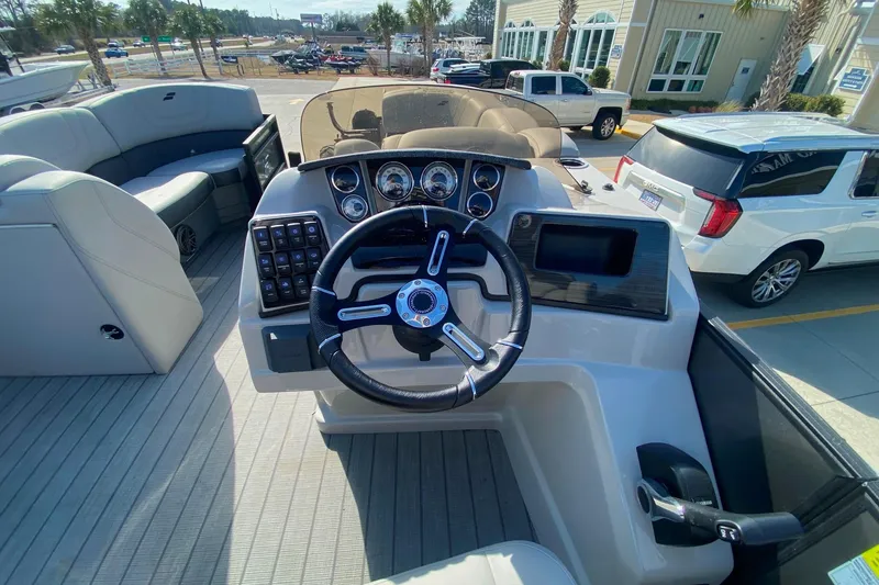 Slide: The Image of 2024 Starcraft SLS 3 boat dashboard with steering wheel and control panel. - 18