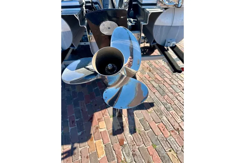 Slide: The Image of 2023 Harris Cruiser 230 boat propeller on brick pavement. - 11