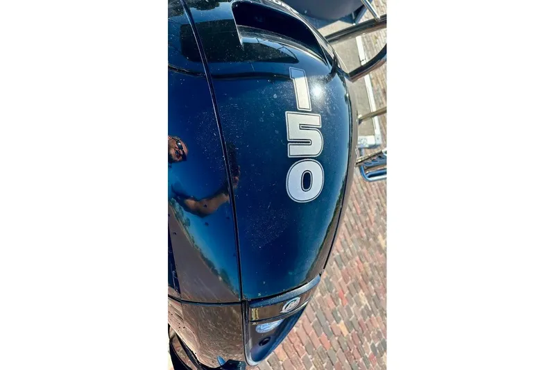 Slide: The Image of Close-up of a 2023 Harris Cruiser 230 boat engine with "150" marking. - 13