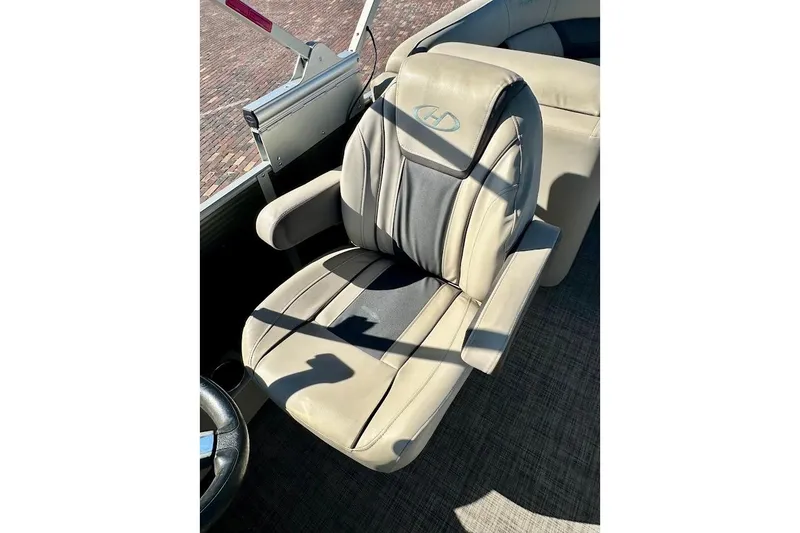 Slide: The Image of 2023 Harris Cruiser 230 boat seat with beige upholstery and armrests. - 17