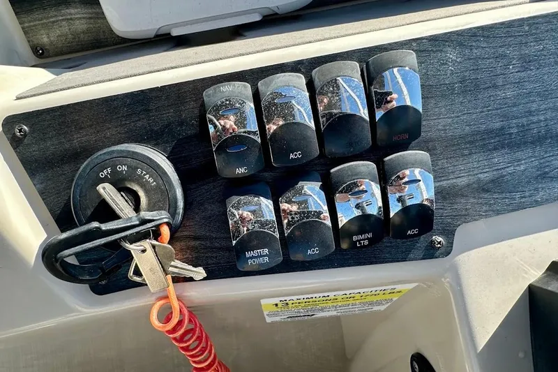 Slide: The Image of Control panel of 2023 Harris Cruiser 230 boat with ignition and switches. - 21