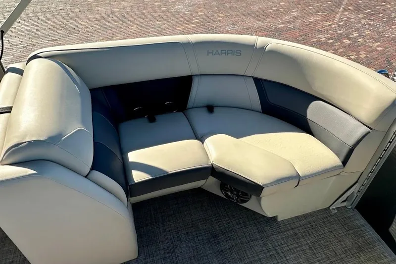 Slide: The Image of 2023 Harris Cruiser 230 boat interior with beige and gray seating. - 23