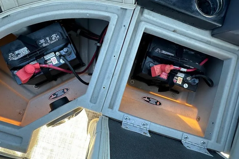 Slide: The Image of Battery compartments of 2023 Harris Cruiser 230 boat, showing dual battery setup. - 26