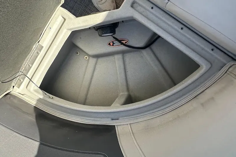 Slide: The Image of Open storage compartment in 2023 Harris Cruiser 230 boat interior. - 28