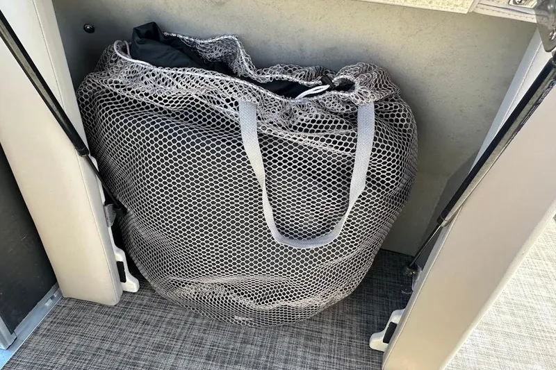 Slide: The Image of Mesh storage bag inside 2023 Harris Cruiser 230 boat compartment. - 30