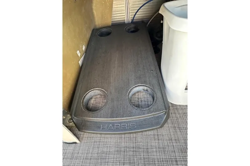 Slide: The Image of 2023 Harris Cruiser 230 boat cup holder with four slots, featuring a sleek design. - 31