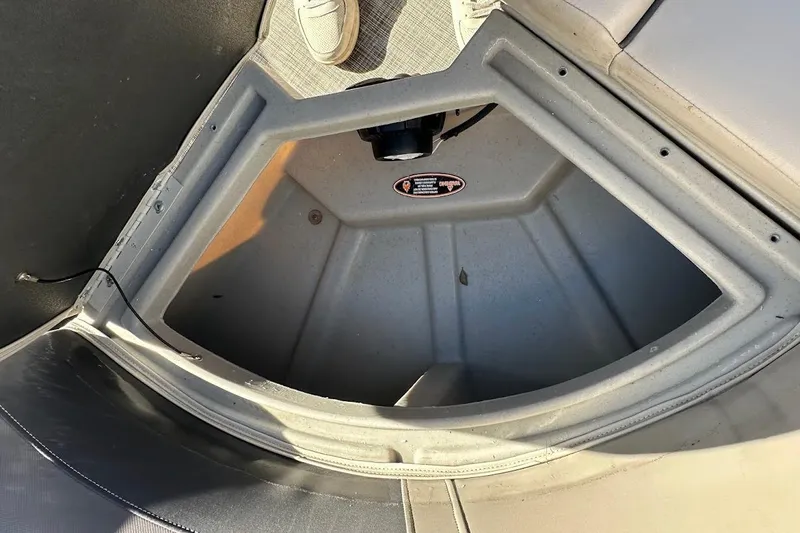 Slide: The Image of 2023 Harris Cruiser 230 storage compartment with open lid, showcasing interior space. - 34
