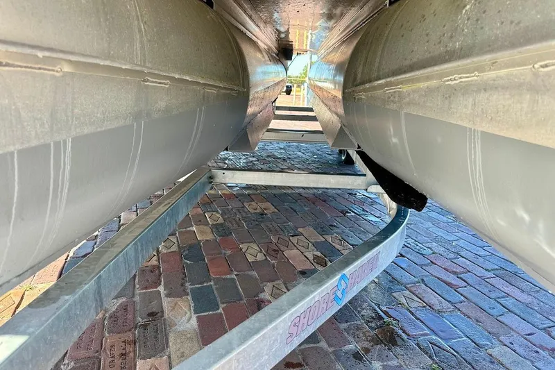 Slide: The Image of Underneath view of 2023 Harris Cruiser 230 pontoon boat on a trailer. - 5