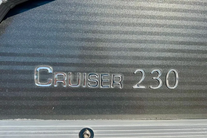 Slide: The Image of 2023 Harris Cruiser 230 logo on metallic surface. - 8