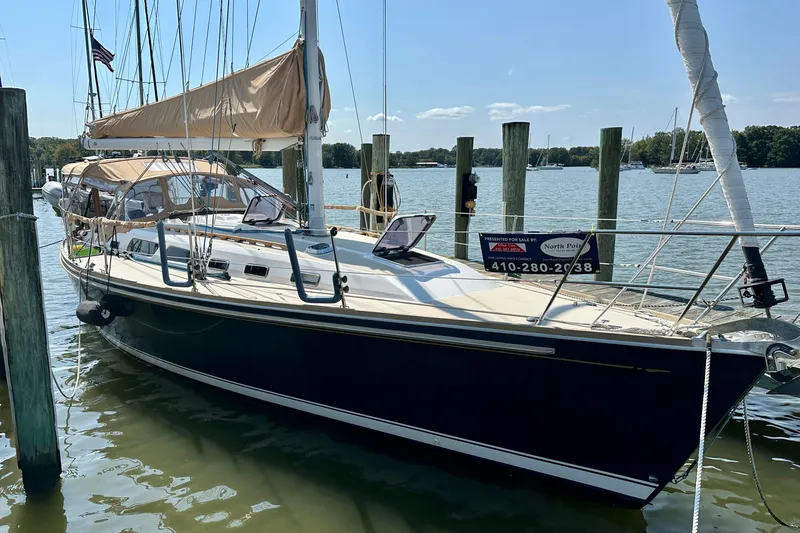 The Image of 2002 Sabre 402 sailboat docked, featuring tan sails and sleek design. - 0