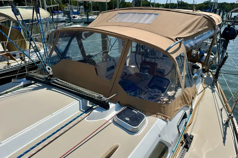 Slide: The Image of 2002 Sabre 402 sailboat with tan canopy docked at marina. - 12