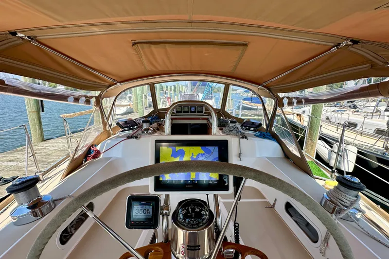 Slide: The Image of Cockpit view of 2002 Sabre 402 sailboat with navigation equipment and steering wheel. - 14