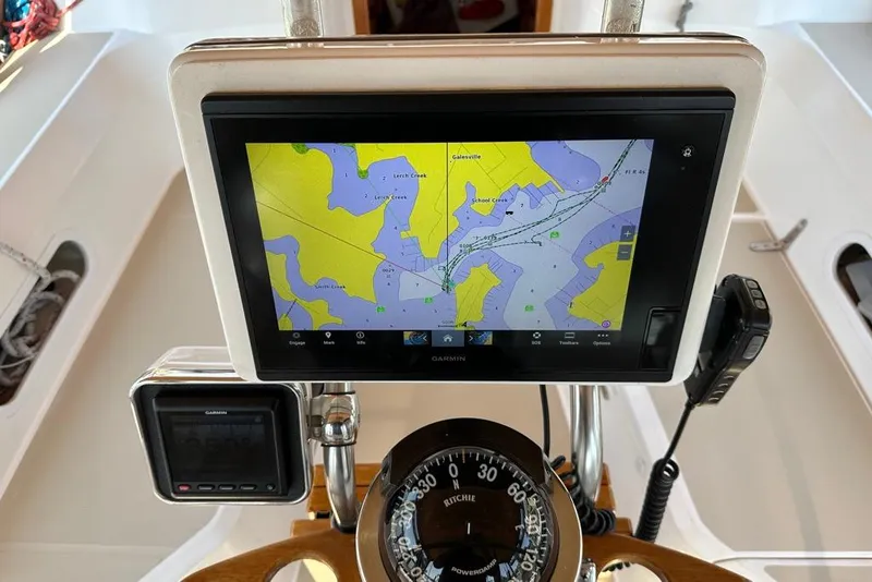 Slide: The Image of Navigation system on a 2002 Sabre 402 sailboat, featuring a Garmin display and compass. - 16