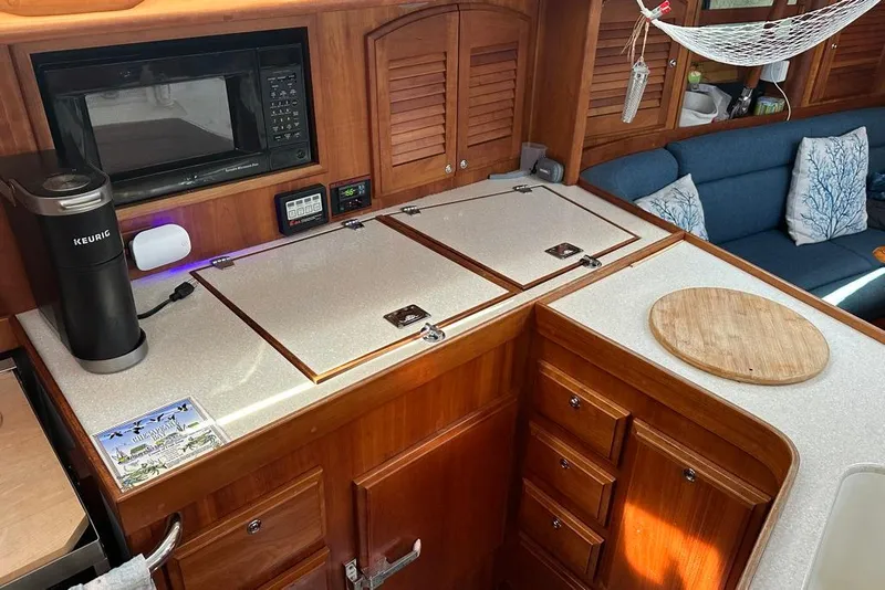 Slide: The Image of Interior of 2002 Sabre 402 yacht kitchen with wooden cabinetry and modern appliances. - 28
