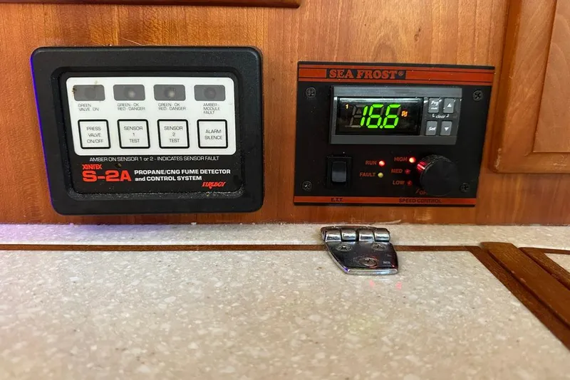 Slide: The Image of Control panel of a 2002 Sabre 402 with fume detector and Sea Frost system. - 30