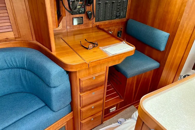 Slide: The Image of Interior of 2002 Sabre 402 yacht with wooden cabinetry and blue seating. - 32