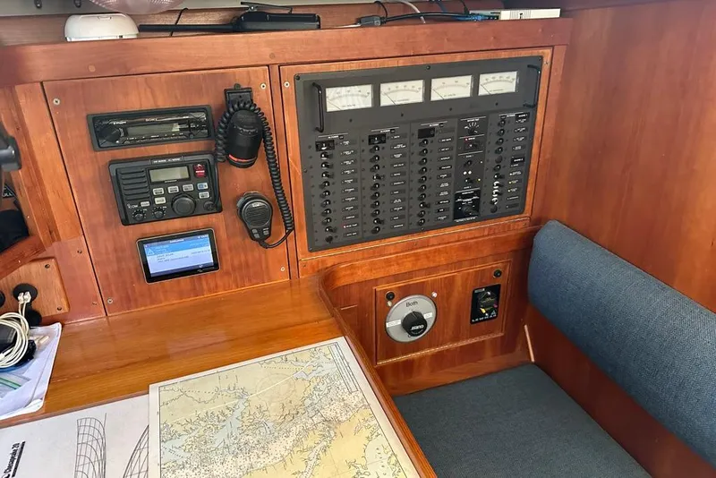 Slide: The Image of Navigation station on a 2002 Sabre 402 sailboat with control panels and map. - 33