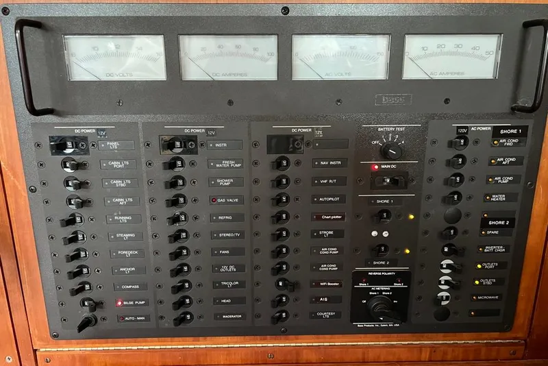 Slide: The Image of Electrical control panel of a 2002 Sabre 402 boat, featuring various switches and gauges. - 35