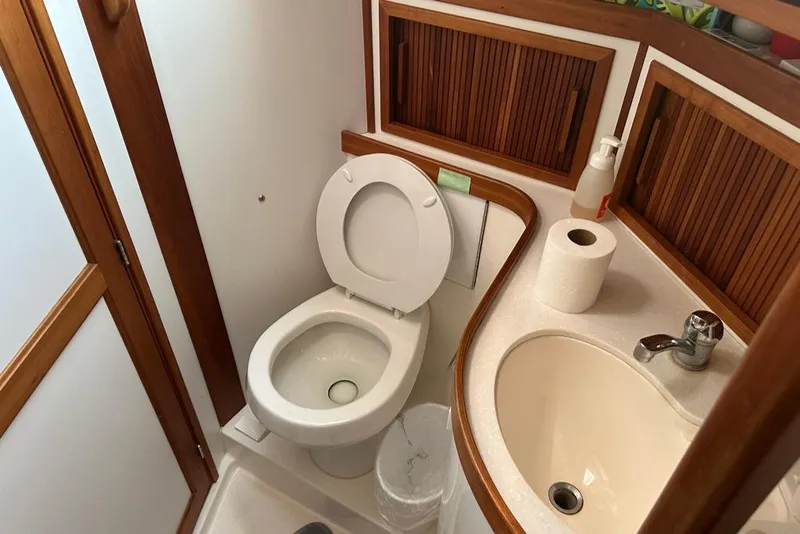 Slide: The Image of Compact bathroom in a 2002 Sabre 402 boat with toilet and sink. - 38