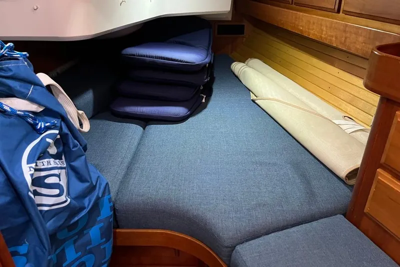 Slide: The Image of Interior cabin of a 2002 Sabre 402 yacht with wooden cabinetry and blue cushions. - 43
