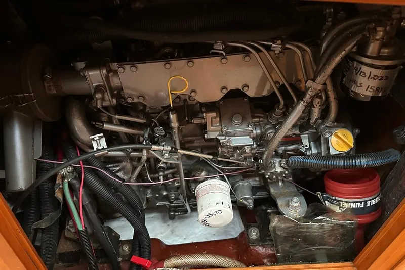 Slide: The Image of Engine compartment of a 2002 Sabre 402 with Yanmar components and red wiring. - 46