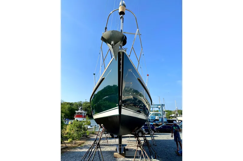 Slide: The Image of Sabre 402 sailboat from 2002 on dry dock, with clear blue sky background. - 5