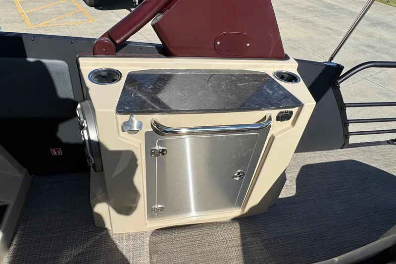 Slide: The Image of 2026 Starcraft RX 25 Q DC boat console with storage and cup holders. - 14