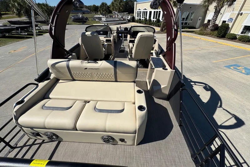 Slide: The Image of 2026 Starcraft RX 25 Q DC boat interior with beige seating and modern design. - 20