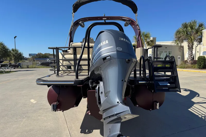 Slide: The Image of 2026 Starcraft RX 25 Q DC boat with Yamaha 300 engine, parked outdoors. - 4