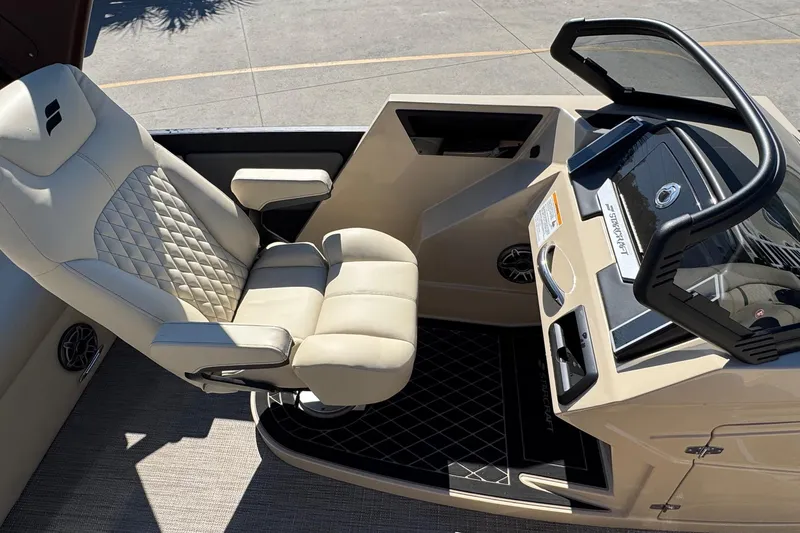 Slide: The Image of Captain's chair and dashboard of 2026 Starcraft RX 25 Q DC boat. - 8