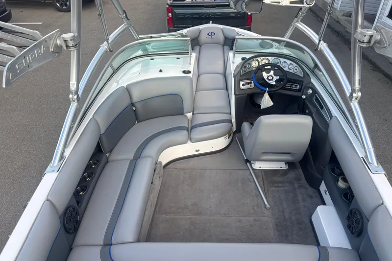 Slide: The Image of 2005 Supra Launch 22 SSV boat interior with gray seating and modern dashboard. - 2