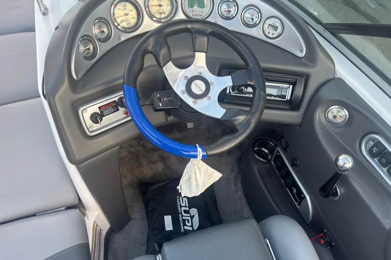 Slide: The Image of 2005 Supra Launch 22 SSV boat dashboard with steering wheel and gauges. - 9