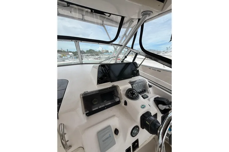Slide: The Image of 2001 Grady-White Marlin 300 boat cockpit with navigation instruments and steering wheel. - 17