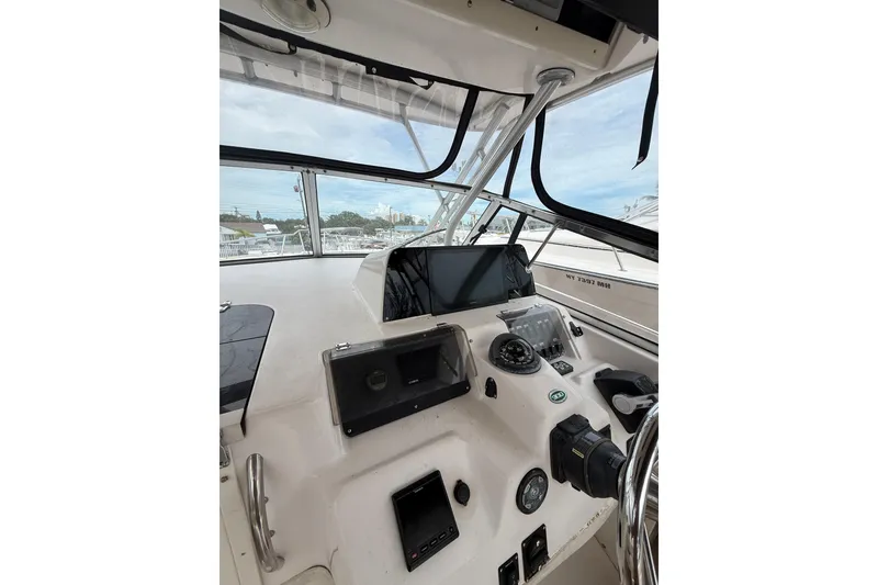 Slide: The Image of 2001 Grady-White Marlin 300 helm with navigation equipment and steering wheel. - 18
