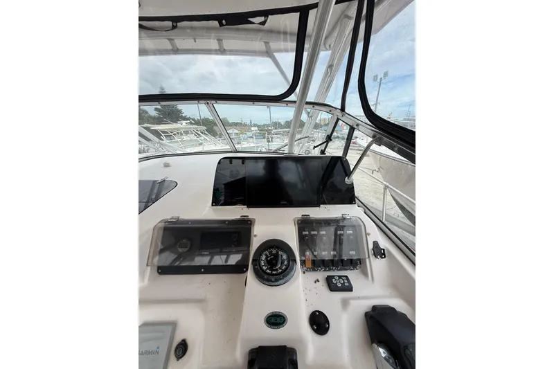 Slide: The Image of 2001 Grady-White Marlin 300 boat dashboard with navigation controls and instruments. - 19
