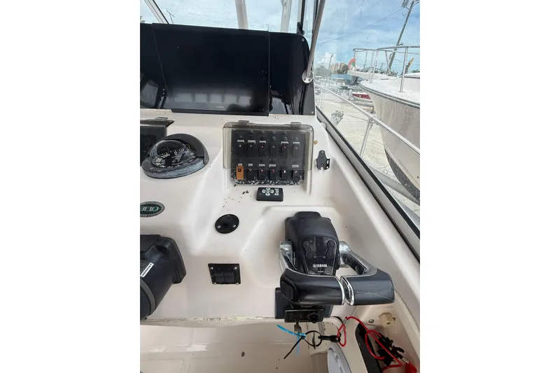 Slide: The Image of 2001 Grady-White Marlin 300 boat dashboard with controls and navigation equipment. - 20