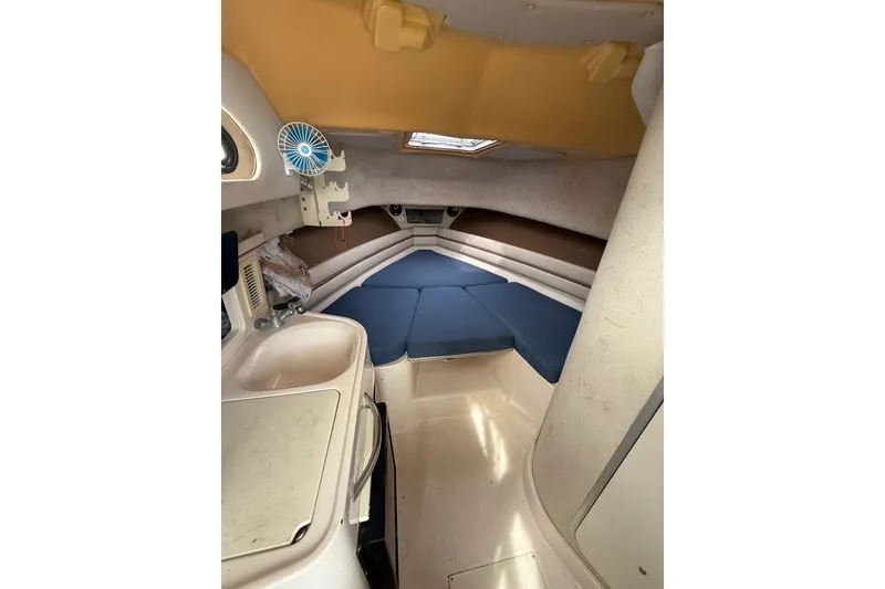 Slide: The Image of 2001 Grady-White Marlin 300 cabin interior with blue cushions and compact amenities. - 24