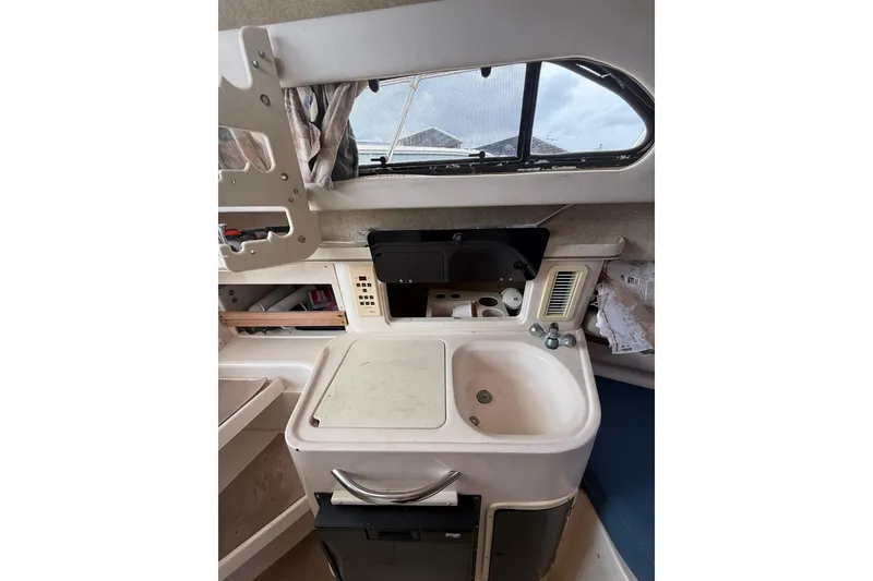 Slide: The Image of 2001 Grady-White Marlin 300 boat interior with sink and storage compartments. - 25