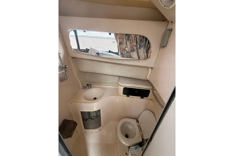 Slide: The Image of 2001 Grady-White Marlin 300 boat bathroom interior with sink and toilet. - 26