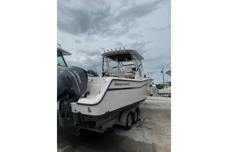 Slide: The Image of 2001 Grady-White Marlin 300 boat with Yamaha engine, docked under cloudy skies. - 29