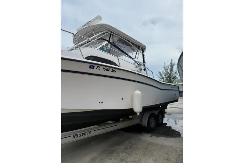 Slide: The Image of 2001 Grady-White Marlin 300 boat on trailer, side view with registration number. - 32