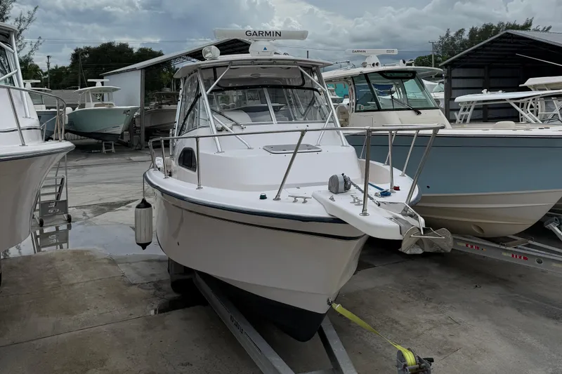 The Image of 2001 Grady-White Marlin 300 boat on trailer, docked in a marina. - 4
