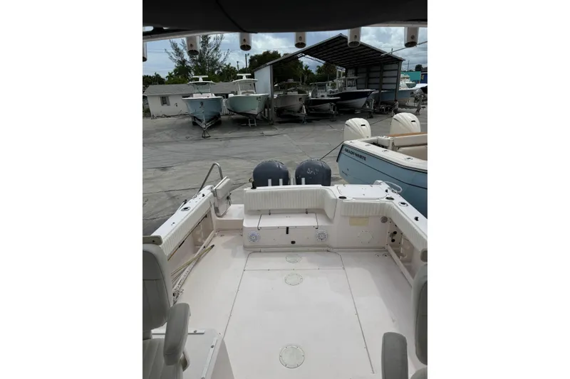 Slide: The Image of 2001 Grady-White Marlin 300 boat interior with dual engines, docked in a marina. - 6