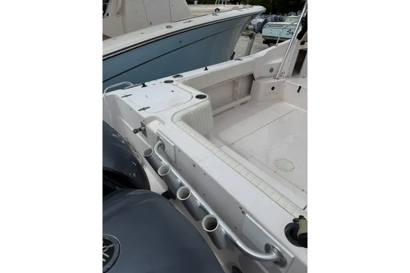 Slide: The Image of 2001 Grady-White Marlin 300 boat deck with rod holders and seating area. - 8