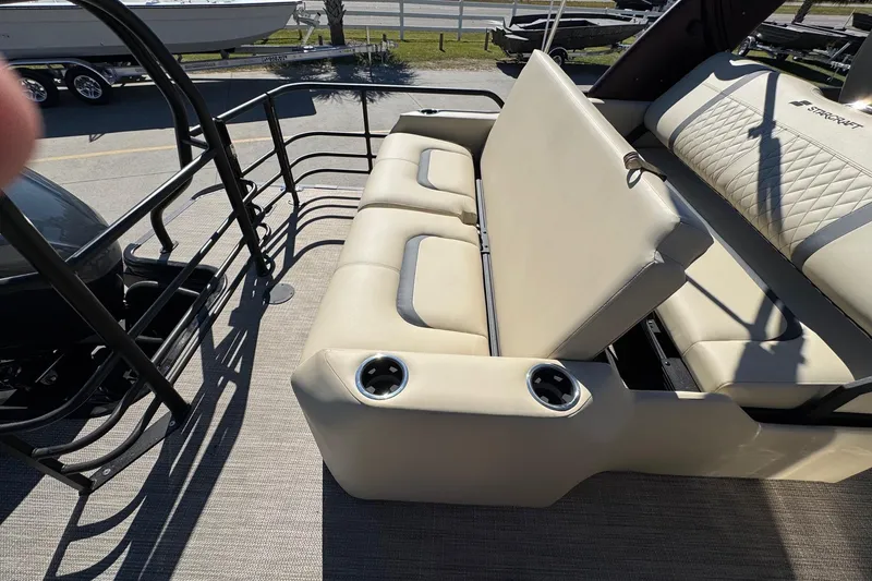 Slide: The Image of 2026 Starcraft RX 25 Q DC boat interior with beige seating and cup holders. - 17