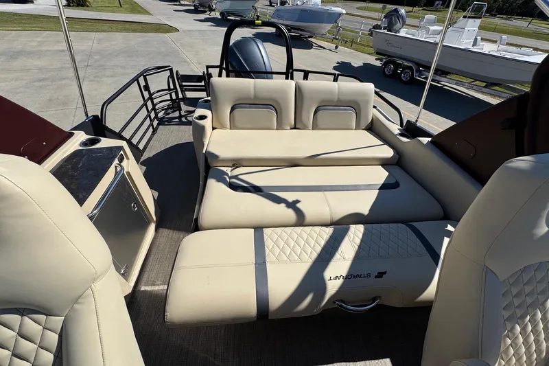 Slide: The Image of 2026 Starcraft RX 25 Q DC boat interior with beige seating and modern design. - 19
