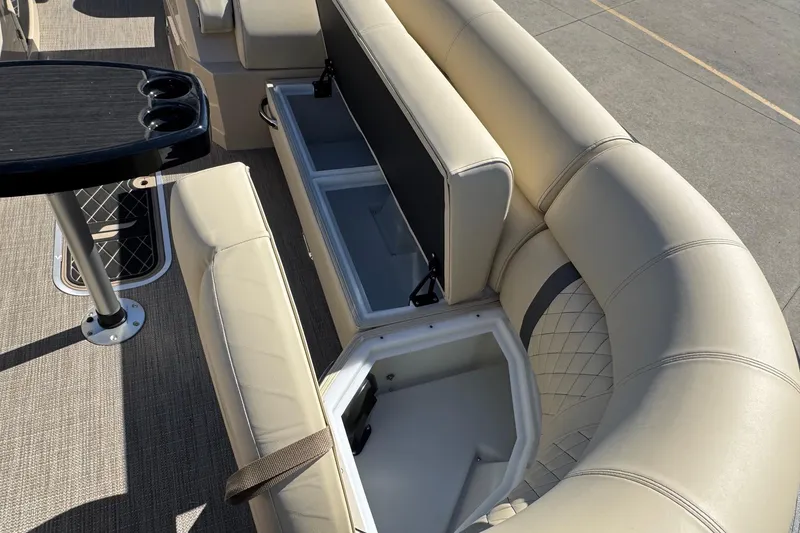 Slide: The Image of Luxurious seating and storage on 2026 Starcraft RX 25 Q DC boat, featuring beige upholstery. - 6
