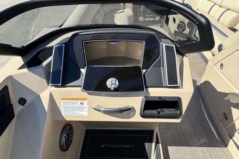 Slide: The Image of 2026 Starcraft RX 25 Q DC boat dashboard with modern controls and sleek design. - 9